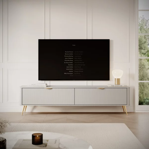 Szafka rtv 200 beżowa dwie klapy złote nogi komoda pod tv Doma E - szafka na wysokich nóżkach w kolorze piaskowy beż z złotymi uchwytami.